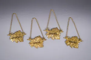 Four Silver Gilt Vine Leaf Decanter Labels by SMD, London, 1968.
