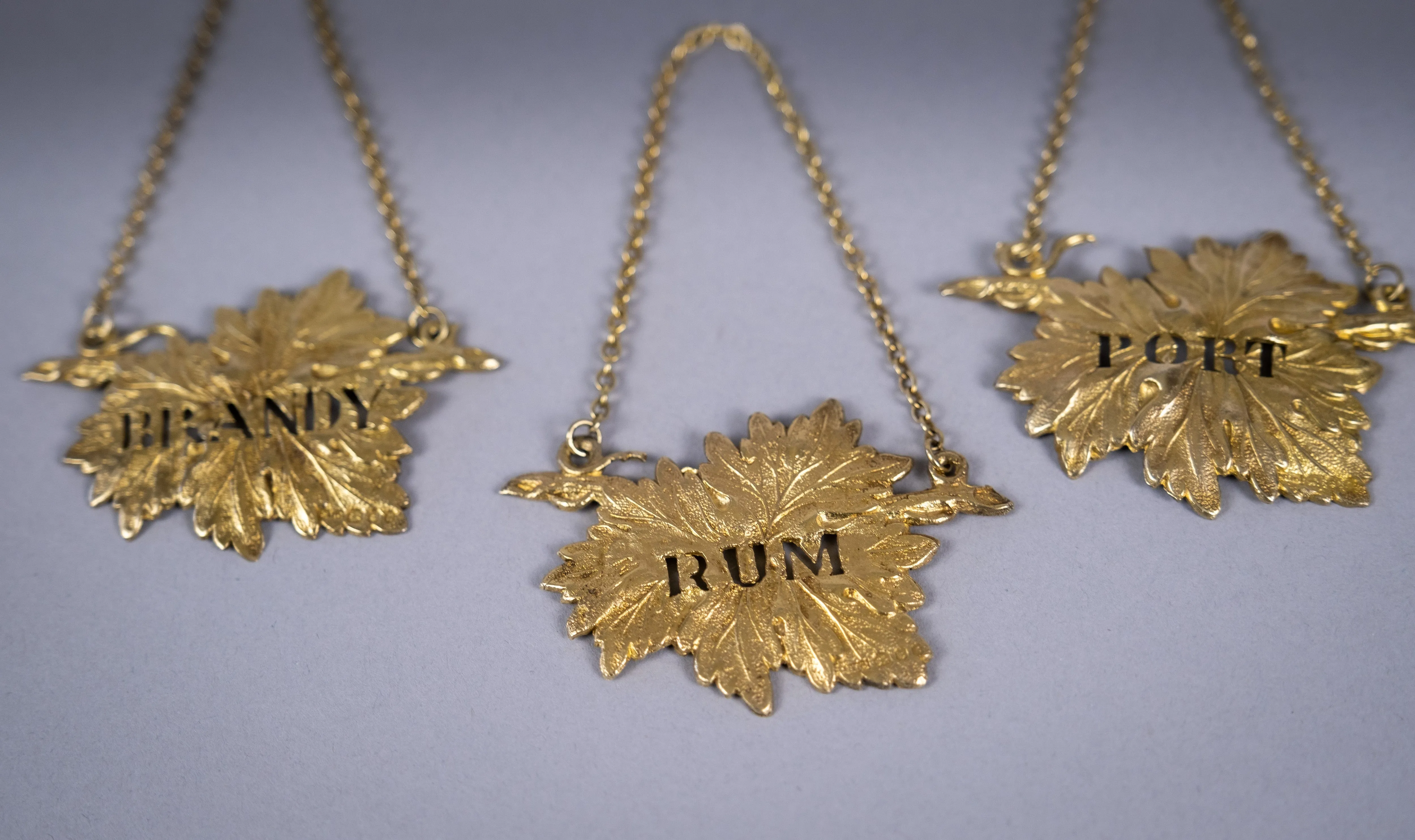 Four Silver Gilt Vine Leaf Decanter Labels by SMD, London, 1968.